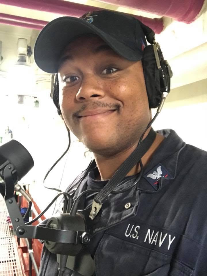 MM1 Ryan Chachere aboard ship in U.S. Navy coveralls